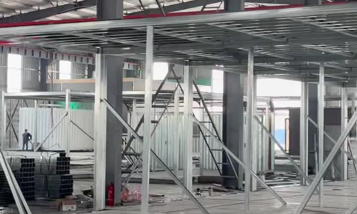 Steel-frame production inside a modular building workshop, reference photograph